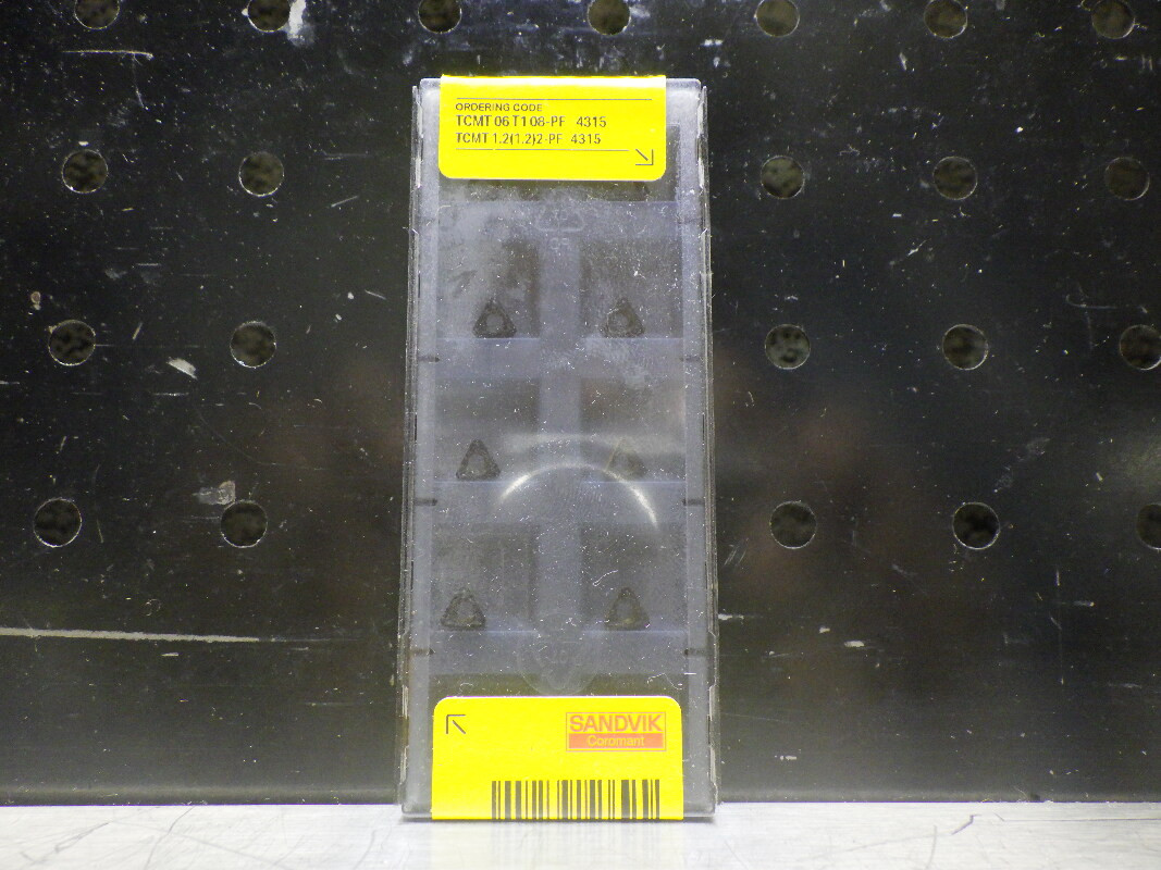 Pack of triangular carbide turning inserts branded Sandvik Coromant, the kind of indexable inserts we stock used and surplus