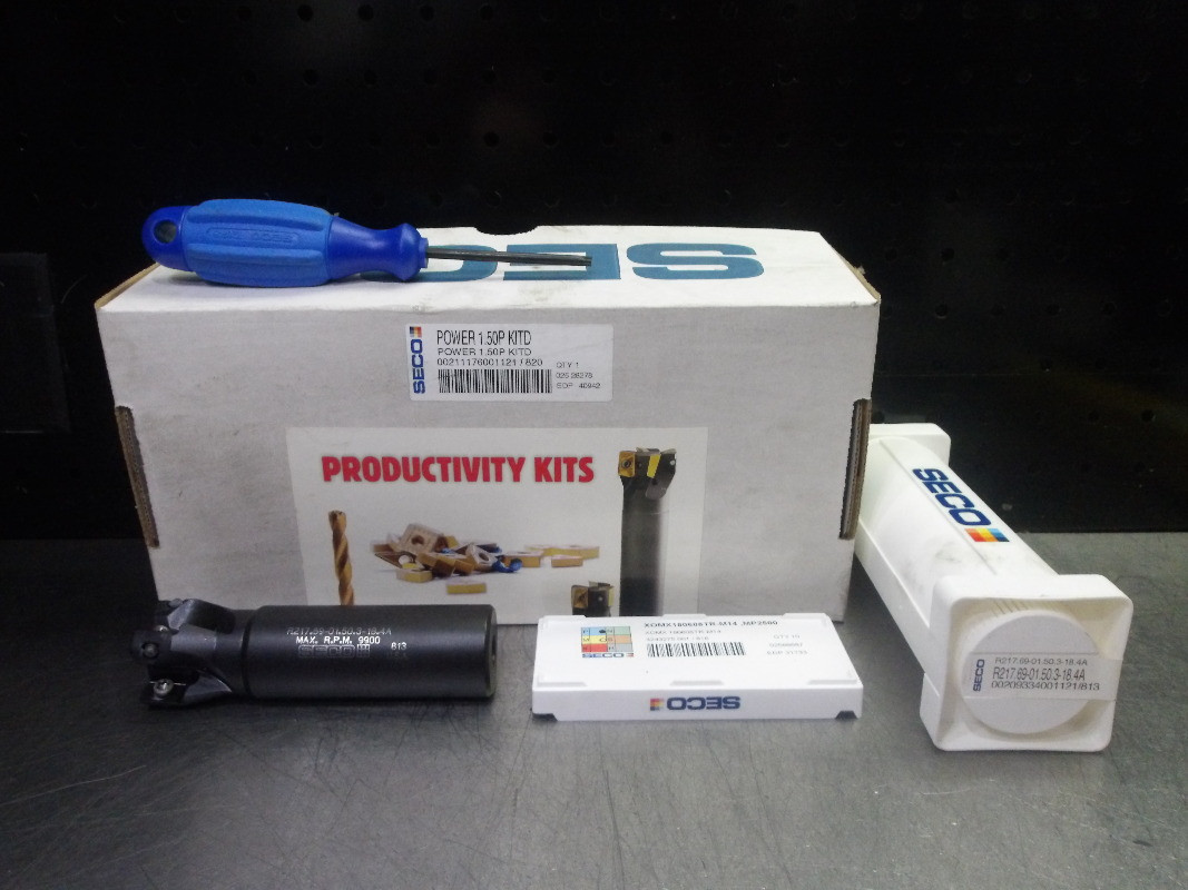 An indexable carbide end mill body, a boring head and a pack of milling inserts laid out together, the kind of CNC carbide tooling we buy, inspect and resell